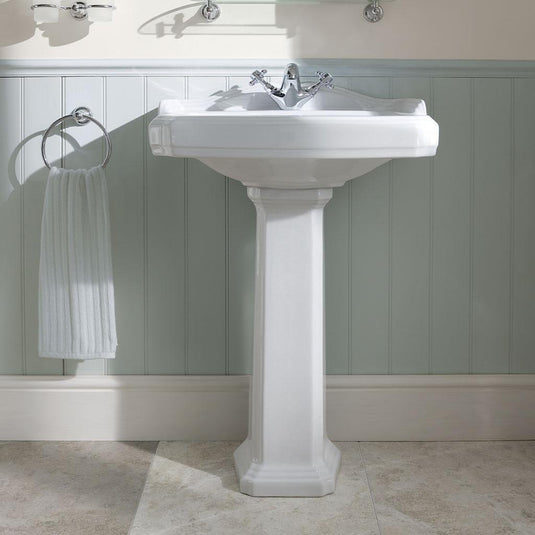 Traditional white pedestal bathroom basin with chrome taps and towel ring