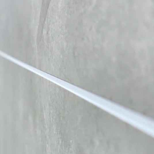 Close-up of grey bathroom wall tile with white grout line