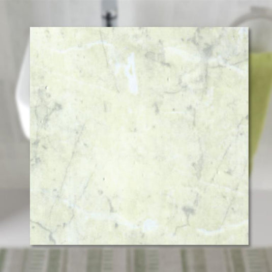 Light marble-effect bathroom wall tile sample with subtle veining, modern decor style