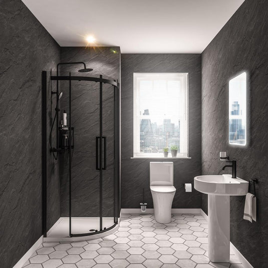 Modern bathroom with black shower enclosure, pedestal sink, toilet, and hexagon floor tiles