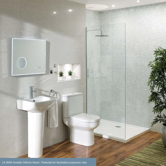 Modern bathroom with pedestal basin, toilet, glass shower enclosure, LED mirror, and tiled walls