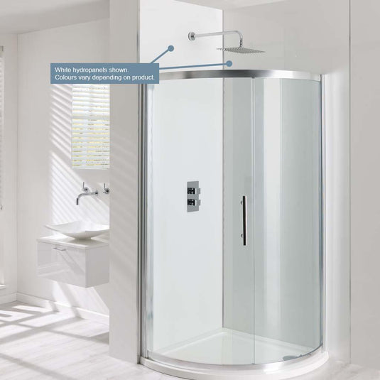 Modern white quadrant shower enclosure with sliding glass door and rainfall shower head in a bright bathroom.