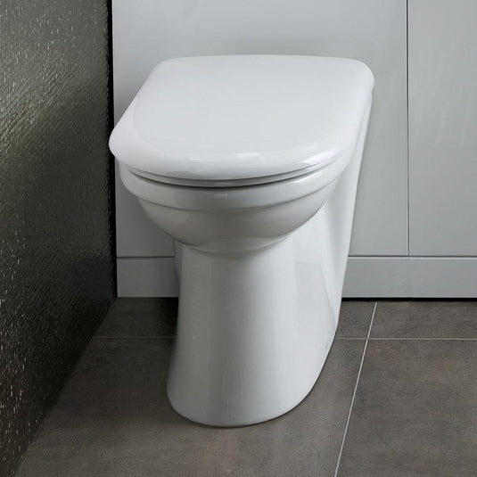 Modern close coupled white ceramic toilet with soft close lid in a contemporary bathroom