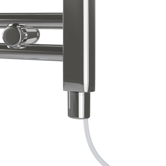 Close-up of chrome electric heated towel rail with power cable in modern bathroom