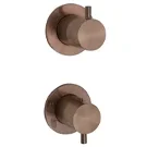 Pair of round brushed bronze bathroom wall mixer valves on white background