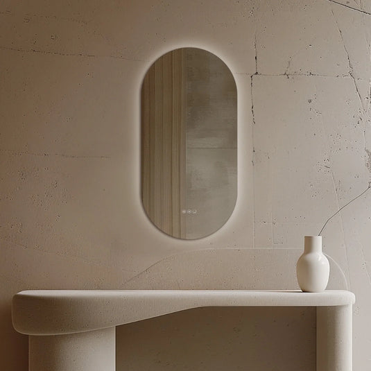 Oval capsule LED bathroom mirror with touch controls in a modern minimalist interior