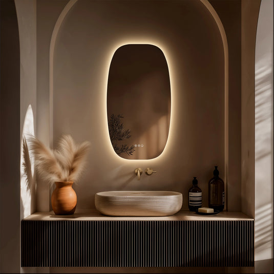 Modern bathroom vanity with backlit oval mirror, vessel sink, pampas grass and gold fixtures