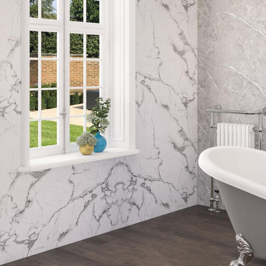 Luxury bathroom with white marble wall panels, clawfoot bathtub, and window view