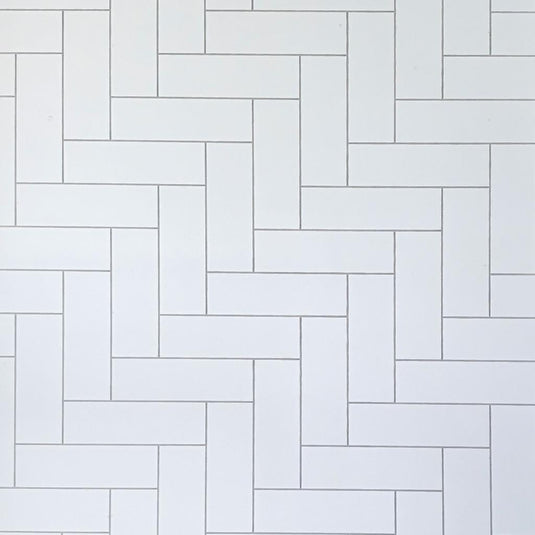 White rectangular bathroom tiles in a vertical herringbone pattern