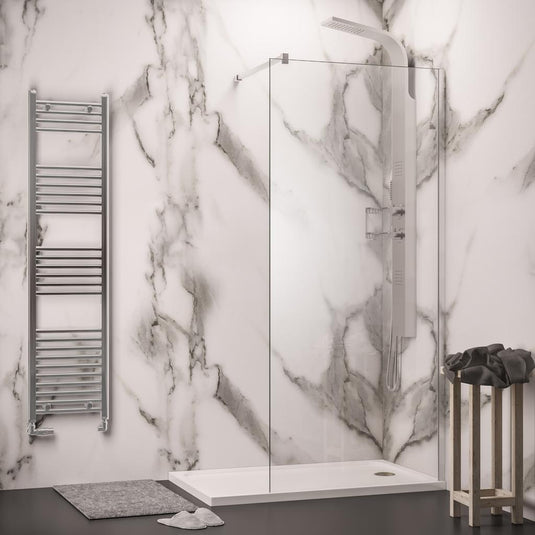 Modern bathroom with marble shower wall, glass shower panel, chrome towel radiator