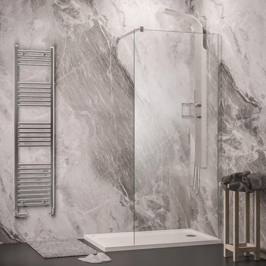 Modern bathroom with marble-effect walls, walk-in shower, glass screen, and chrome towel rail