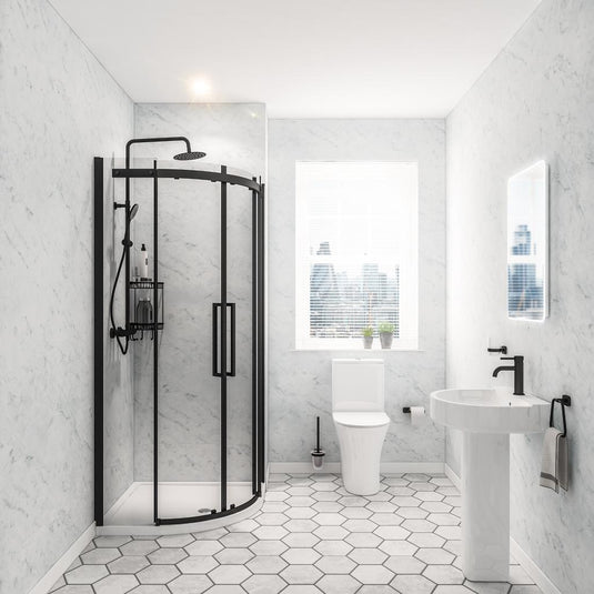 Modern bathroom with black-framed shower, white toilet, pedestal sink and hexagon tiles