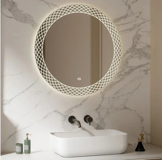 Modern bathroom with round LED backlit mirror, marble wall, and white rectangular basin