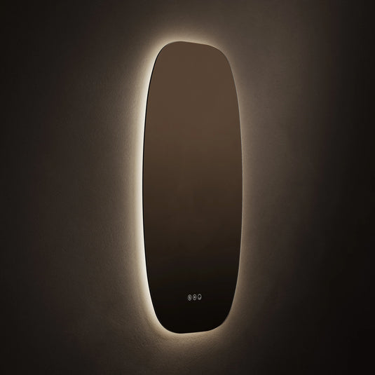 Modern rectangular bathroom mirror with rounded corners and LED backlighting mounted on a wall