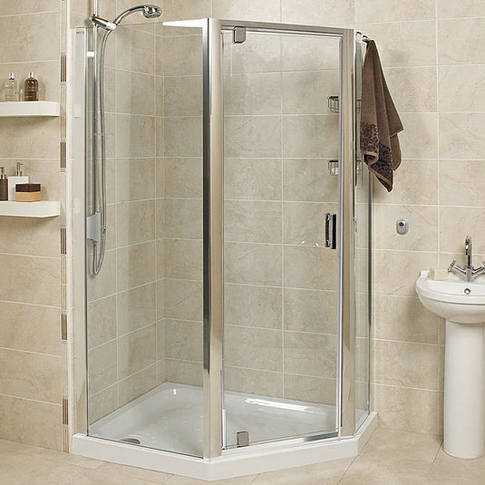 Modern corner shower enclosure with glass doors and chrome trim in tiled bathroom