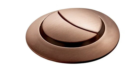 Brushed copper bath waste button with modern circular design on white background
